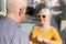 Elderly, deaf man uses a hearing aid