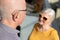 Elderly, deaf man uses a hearing aid