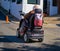 Elderly disabled person or senior with a dog on electric wheelchair