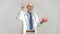 Elderly doctor holding a brain model and pointing up with his finger