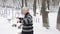 An elderly European man does a morning outdoor warm-up in the winter, exercise for a warm-up of the back. Healthy life