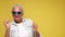 Elderly European woman in sunglasses is dancing