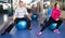 Elderly exercise with gymnastic balls in modern gym