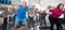 Elderly exercise with gymnastic sticks in modern gym