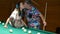 Elderly family. Senior man and woman relax and have fun in billiard room.