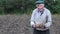 Elderly farmer holding fresh potatoes. This is a vegetative concept. Eco vegetables concept.