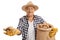 Elderly farmer holding potatoes and burlap sack filled with potatoes