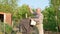 elderly farmer makes a scarecrow in the garden