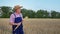 Elderly farmer in straw hat with ears of wheat in his hands i