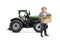 Elderly farmer with a tractor carrying a wooden crate full of vegetables