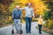 Elderly father, adult son and grandson out for a walk in the park