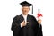 Elderly female in a graduation gown holding a diploma and pointing