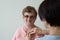 Elderly female patient  medical exam glasses white background