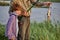 Elderly Fisherman with grandson enjoys in fishing on river. Sport, lifestyle