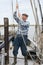 Elderly Fisherman Pulling Rope On Deck