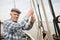 Elderly Fisherman Pulling Rope On Deck