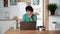 Elderly focused woman remotely working on laptop at home. Older People
