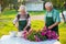 Elderly gardeners working with flowers.