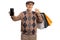 Elderly gentleman showing a mobile phone and holding shopping bags