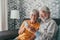 Elderly grandfather and grandmother spend time having fun using smartphone apps, middle-aged wife enjoy online entertainments,