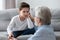 Elderly grandfather and little grandson having heart to heart talk