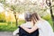 Elderly grandmother in wheelchair with granddaughter in spring nature.