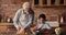 Elderly grandpa and little grandson cooking together in kitchen