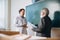 Elderly gray-headed man, professor, teacher and student at lecture, lesson at classroom, indoors. Concept of