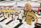 elderly grayhaired man pensioner examining counter with electronic gadgets and smart watches in showroom of digital