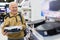 elderly grayhaired man pensioner looking robot hoover at counter in showroom of electrical appliance hypermarket