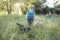 Elderly grayhaired woman with her lovely dogs in the park