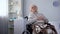 Elderly handicapped woman feeling chest pain, heart arrhythmia, health care