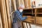 Elderly handyman with mask repairs cabinet