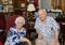 Elderly happily married couple celebrating the wife`s 87th birthday in their home.