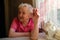 Elderly happy woman in her home, portrait at kitchen.