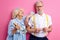 elderly happy woman holding alcohol beverage in hands, celebrating with husband