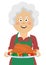 Elderly happy woman holding a tray with thanksgiving turkey