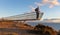 An elderly hiker stands on the Sky Walk at the Santa Pola lighthouse in Spain.