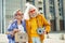 Elderly hippies wearing bright floral shirts laying music instruments