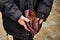 An elderly homeless poor woman holds an empty wallet, or purse. The concept of poverty in retirement. Global Extreme poverty.