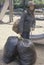 Elderly homeless woman holding possessions in garbage bags, Chicago, Illinois