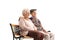 Elderly husband and wife sitting on a bench and looking away