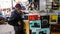 An elderly Indian man standing outside a music store