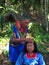 Elderly indigenous shaman of Cofan nationality performing healing ritual to a Cofan woman in the Amazon rainforest