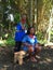 Elderly indigenous shaman of Cofan nationality performing healing ritual to a Cofan woman in the Amazon rainforest