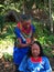 Elderly indigenous shaman of Cofan nationality performing healing ritual to a Cofan woman in the Amazon rainforest