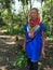 Elderly indigenous shaman of Cofan nationality walking head-on through the jungle in the Amazon