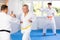 Elderly karate fighter engaging kumite with male rival