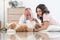 Elderly kind father with beautiful teenage daughter playing with shih tzu puppy dog at home. Caucasian family lying on floor