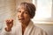 Elderly lady brushes her teeth with a toothbrush and toothpaste